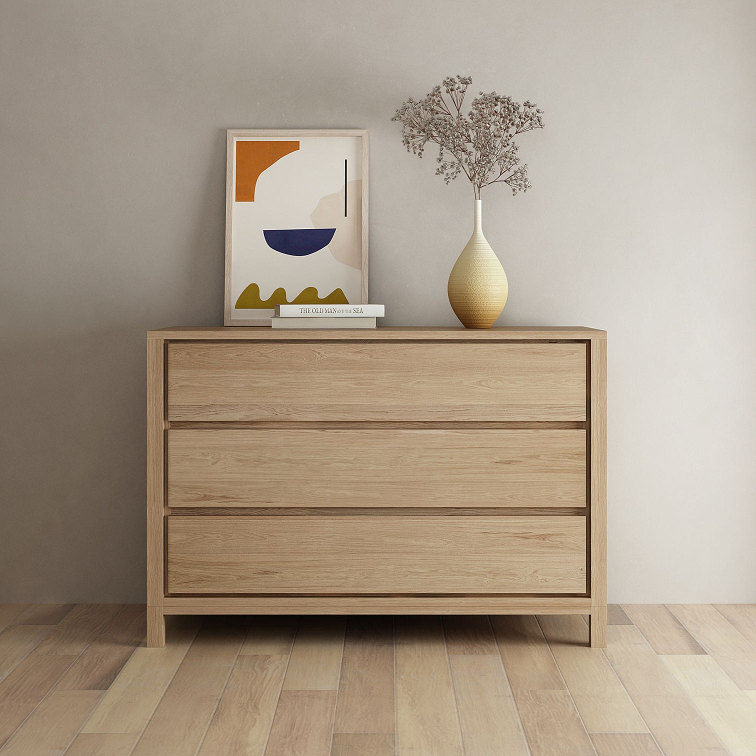 Modern wooden dresser with art and vase.